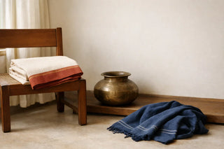 Curated handloom textiles and handmade home objects arranged to showcase timeless, quality craftsmanship and sustainable design
