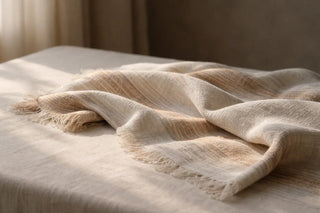 Handwoven textile draped naturally, representing conscious consumption through quality craftsmanship and timeless design
