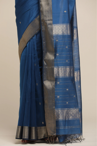 Blue saree with silver border on a beige background