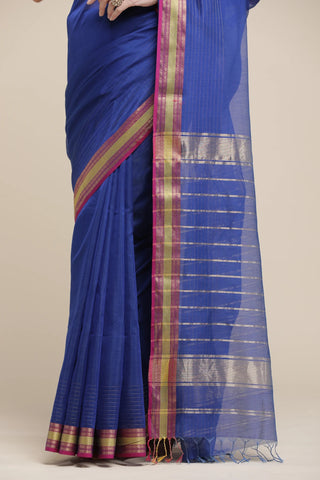 Blue saree with a checkered border on a beige background