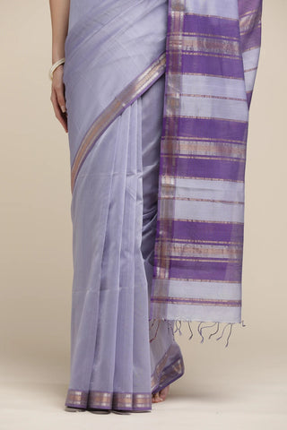 Saree with a purple and white striped border on a beige background