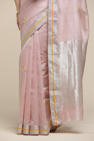 Pink saree with yellow border on a beige background
