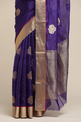 Purple saree with gold and silver border on a plain background