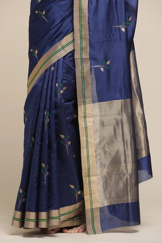 Navy blue saree with gold and green border on a neutral background