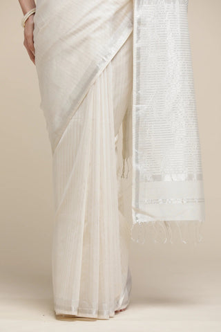 White saree with a subtle pattern on a beige background
