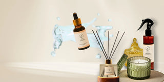 Collection of wellness products including a diffuser, candles, and bottles on a light background